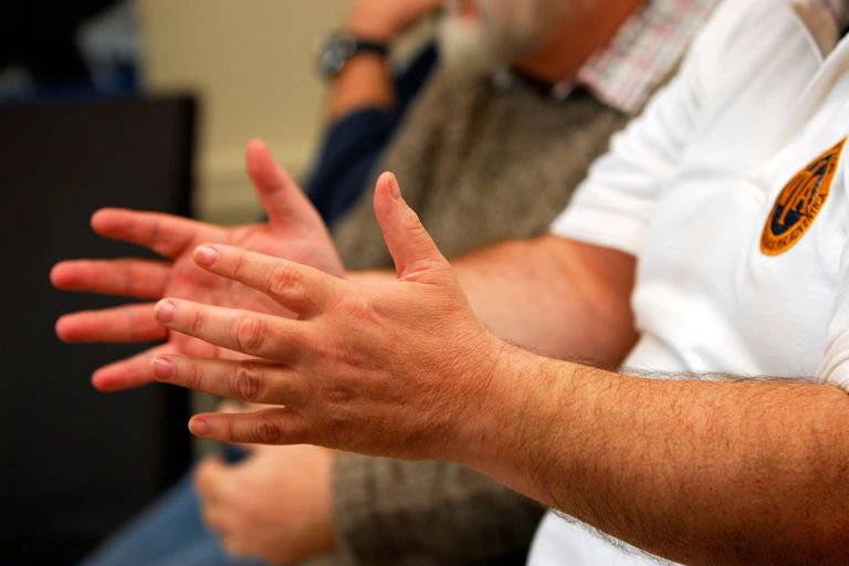 Close up of a man's arm while he's articulating a point