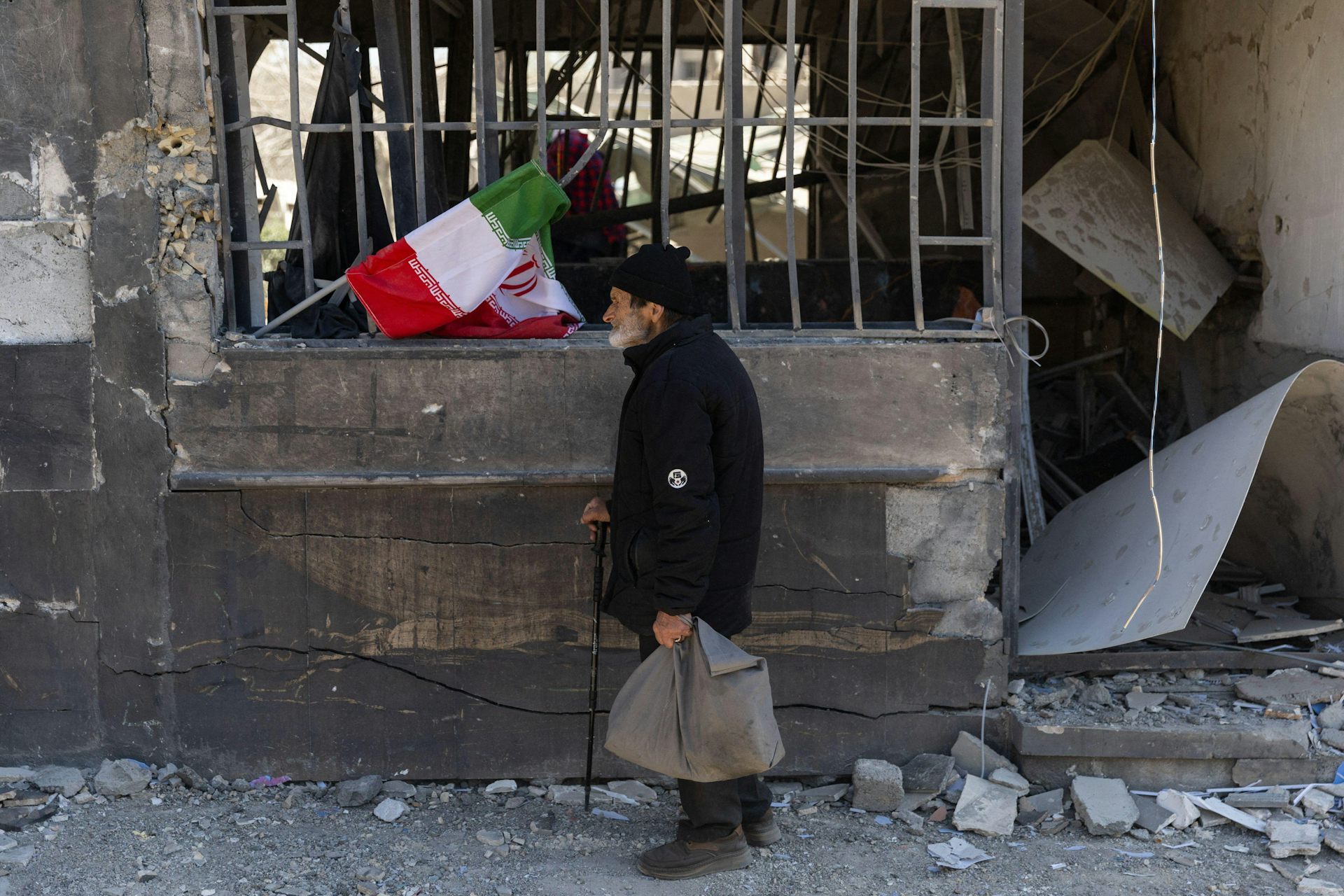 A man walks past the damaged site of one of the judiciary buildings in Tehran's Grand Bazaar.