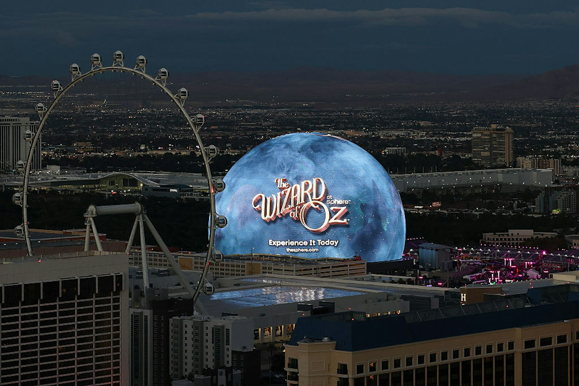 A landscape image of a city featuring casinos, a ferris wheel and a blue, glowing orb.