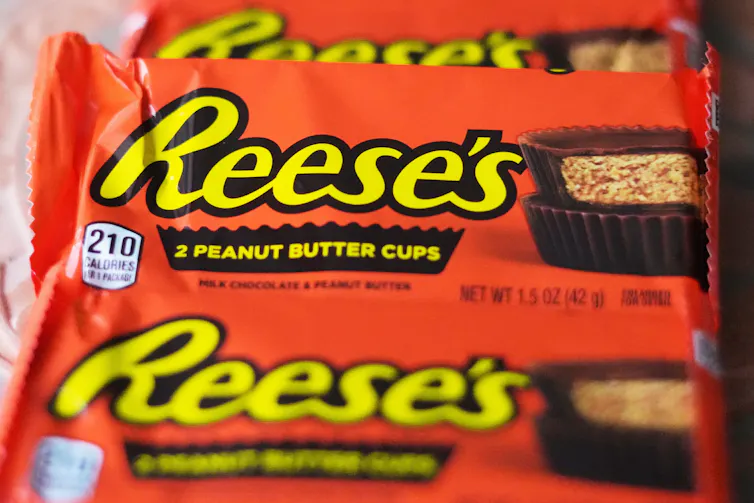 Three wrapped packages of Reese's peanut butter cups