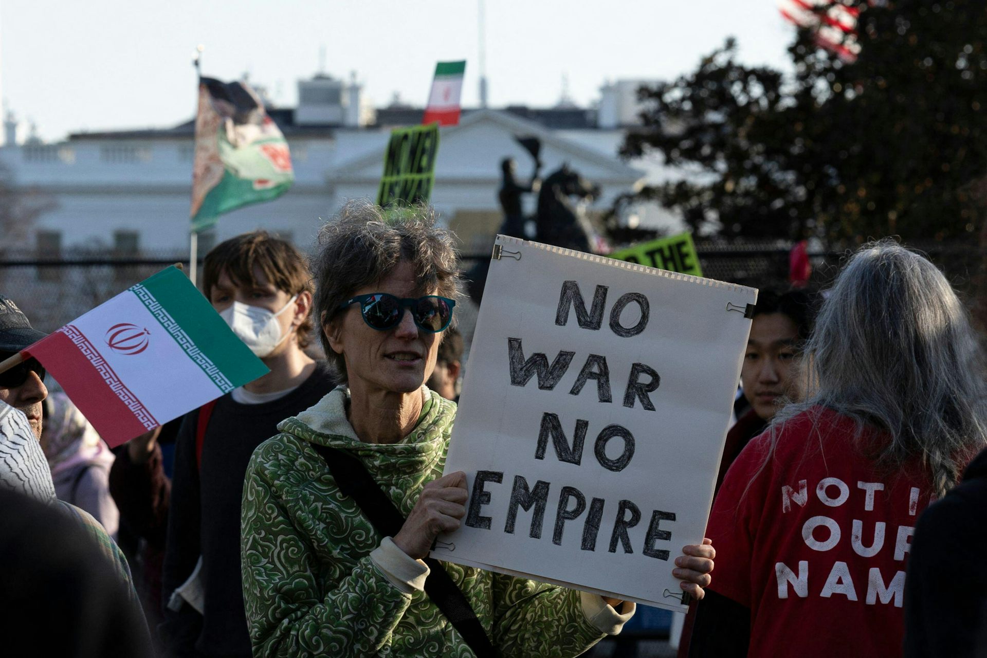 Demonstrators against the war aganst Iran hold up anti-war banners.