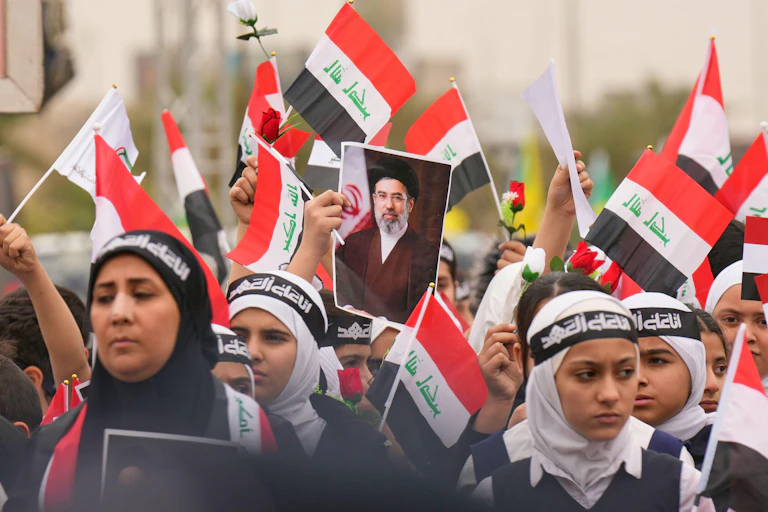 Supporters hold up pictures of Iran's newly appointed supreme leader, Ayatollah Mojtaba Khamenei.