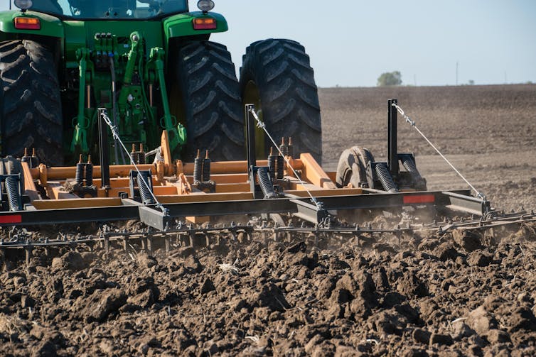 Tractor and ploughing equipment on a farm