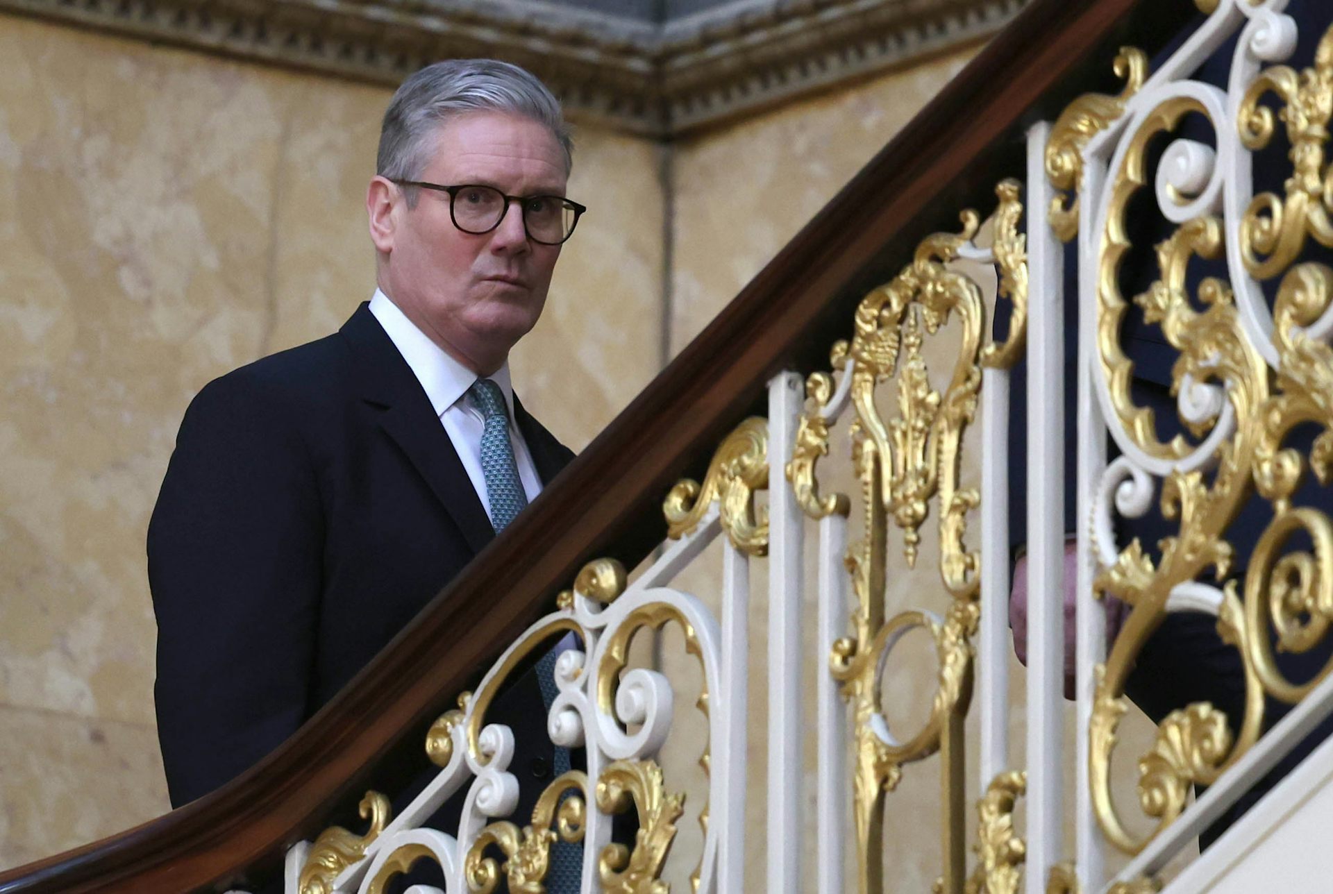 Keir Starmer walking up some stairs
