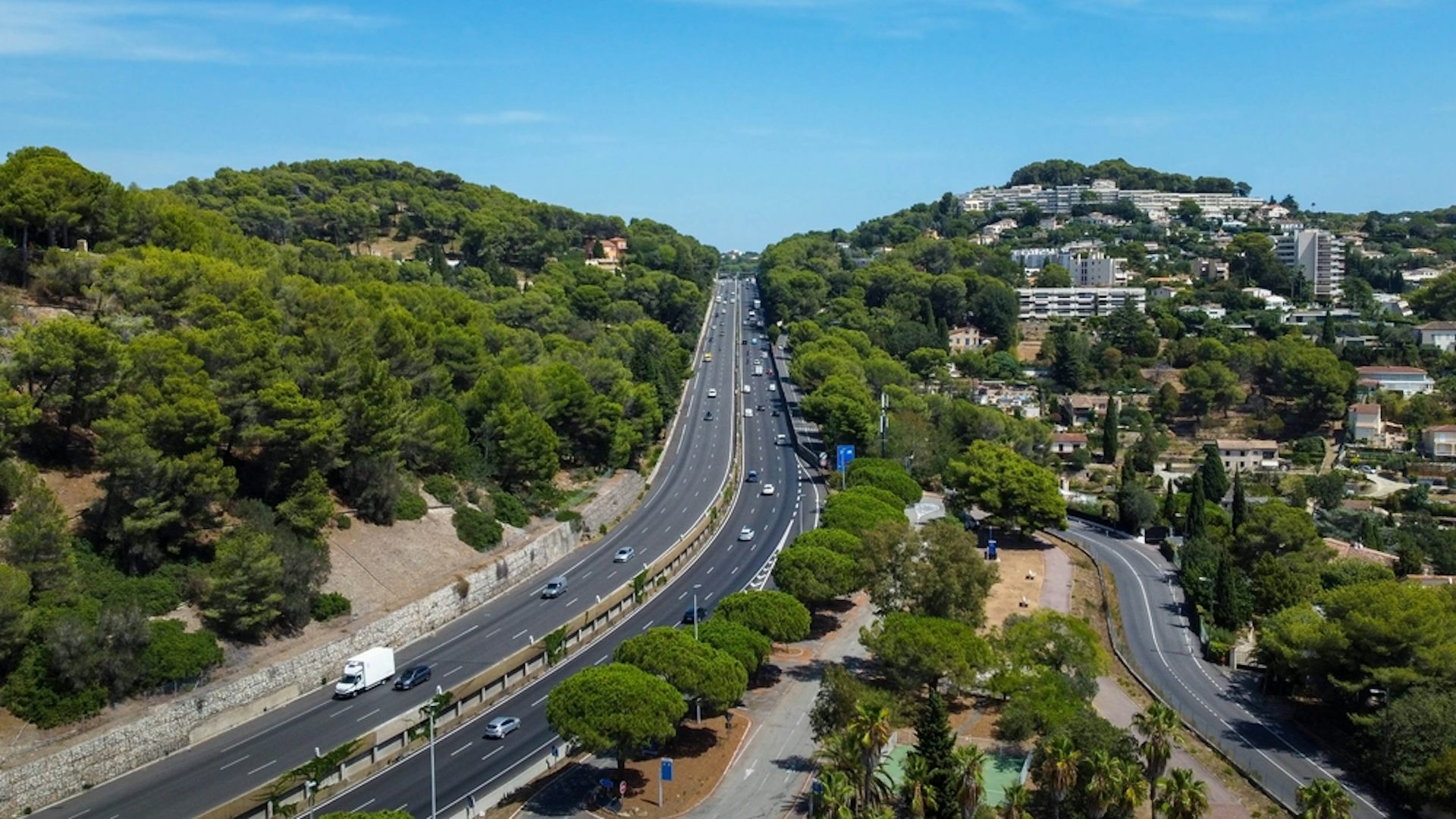 A large French road, with trees nearby.