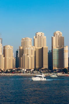 A yacht on the sea in front of Dubai skyscrapers