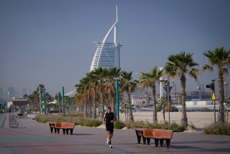 Man seen jogging in front of the Burj Al Arab luxury hotel in Dubai