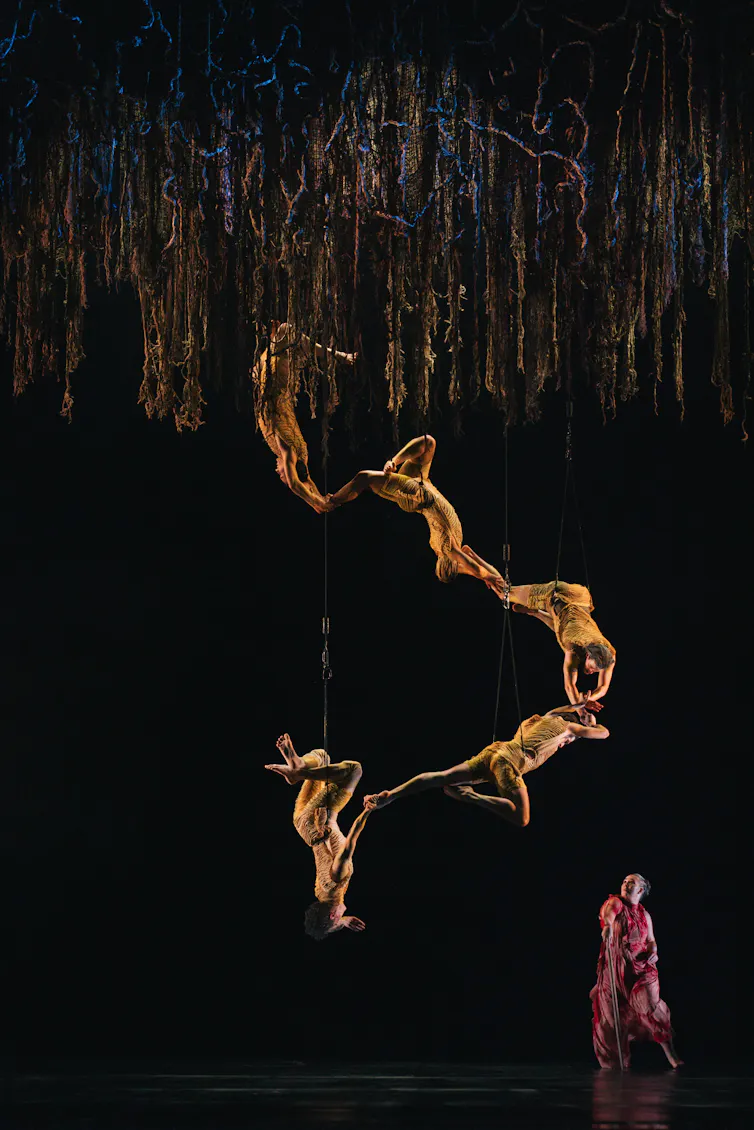 Five dancers suspended from the ceiling.