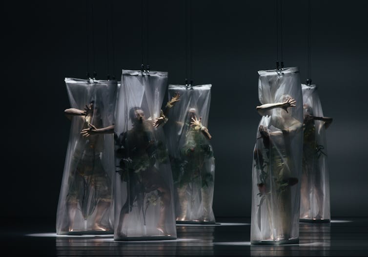 Five dancers in white nets.