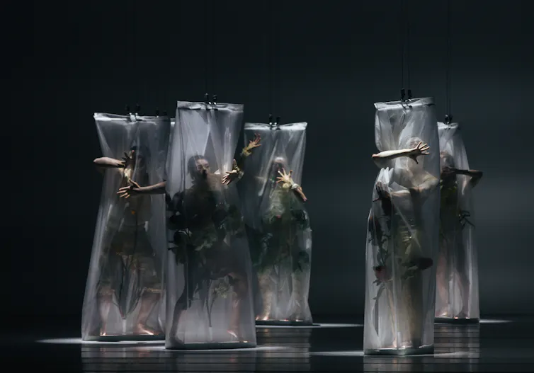 Five dancers in white nets.