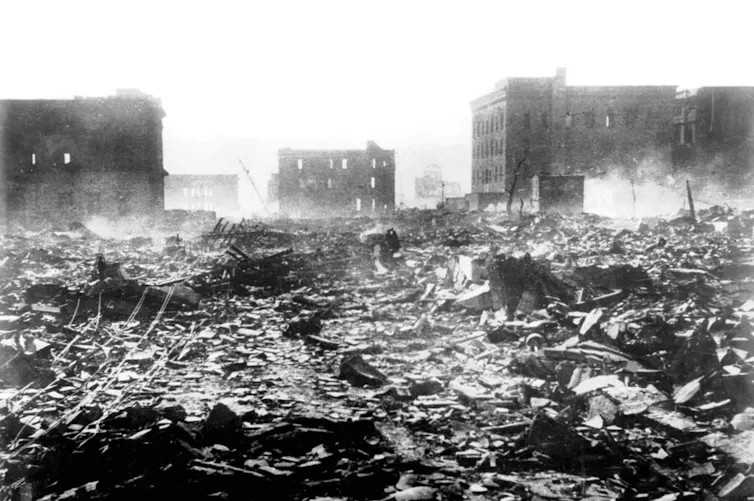 A city lies in ruins after a nuclear bomb detonation.