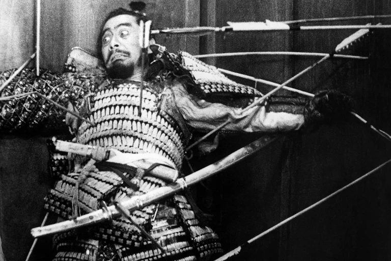 A man pinned to a door by arrows