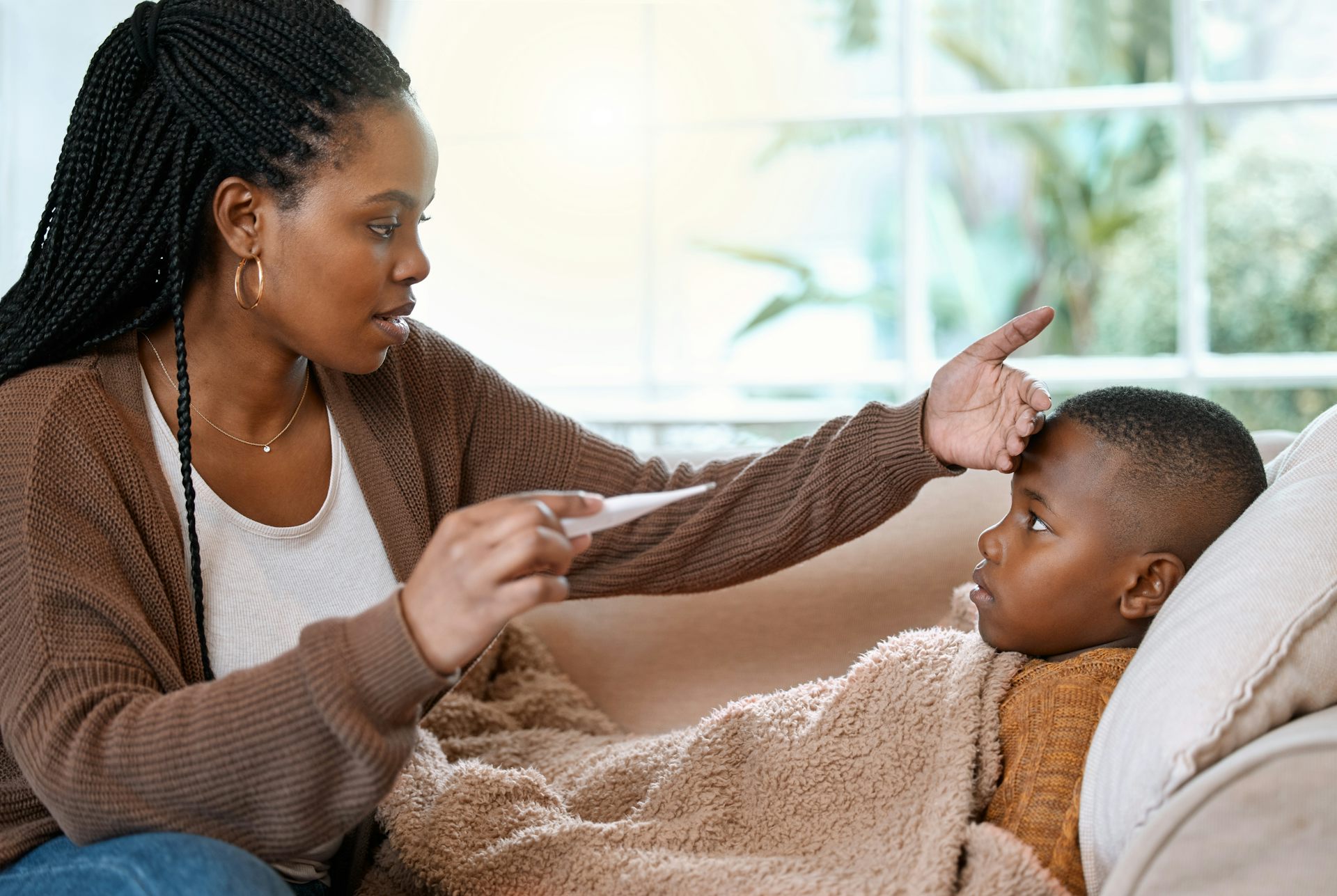 Mother checks son's temperature