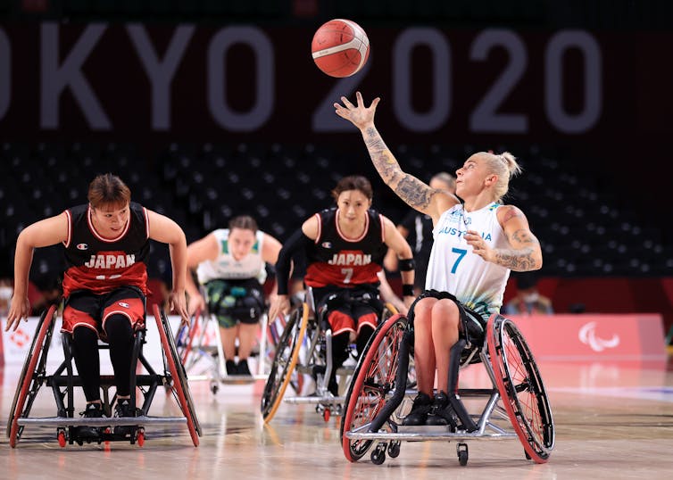 Shelley Cronau, a player on Australia's Paralympics wheelchair basketball team, grabs a loose ball in a match against Japan in the Tokyo 2020 Paralympic Games.