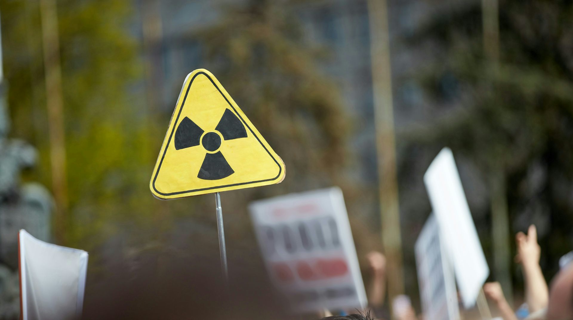 a yellow sign with a nuclear logo