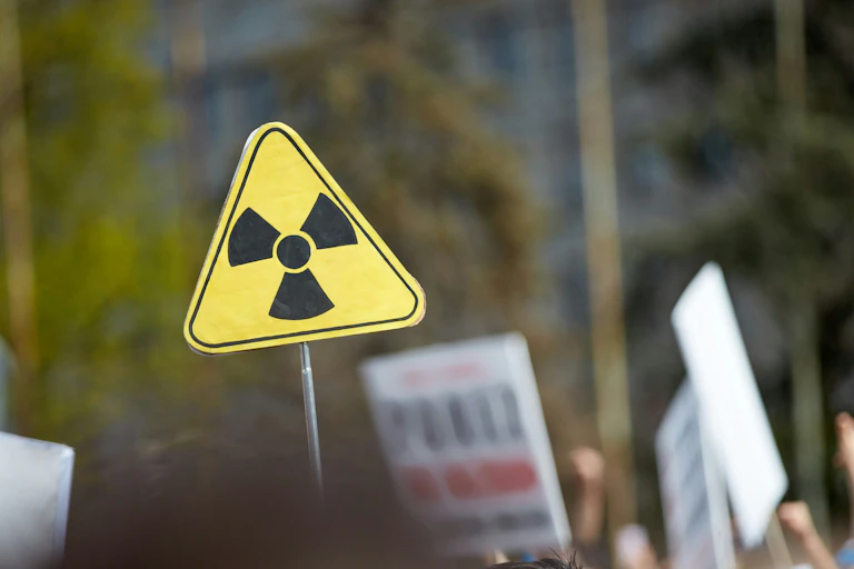 a yellow sign with a nuclear logo