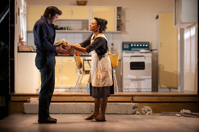 Production image: the pair in a kitchen.
