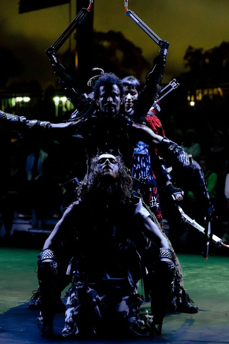 Dancers looking like strange aliens.