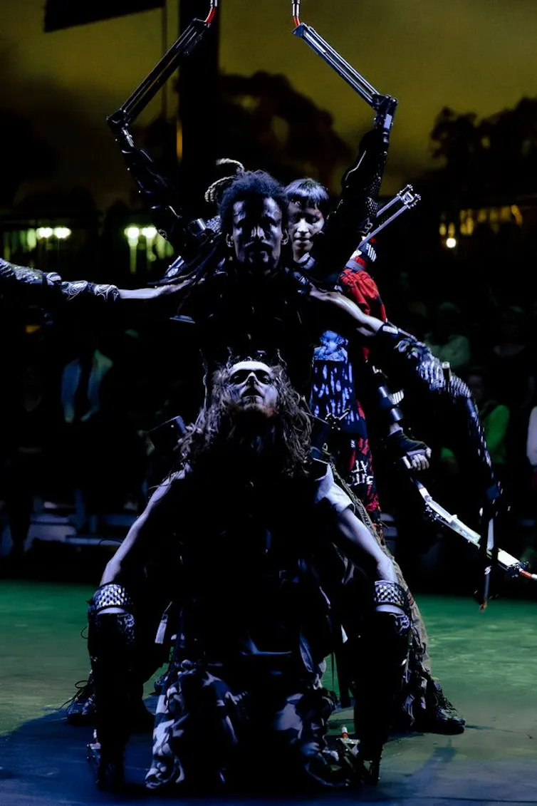 Dancers looking like strange aliens.