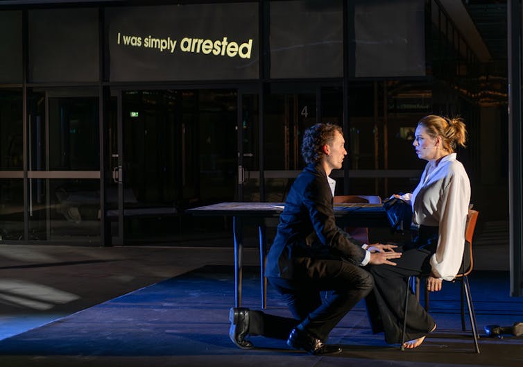 A couple on stage talk.