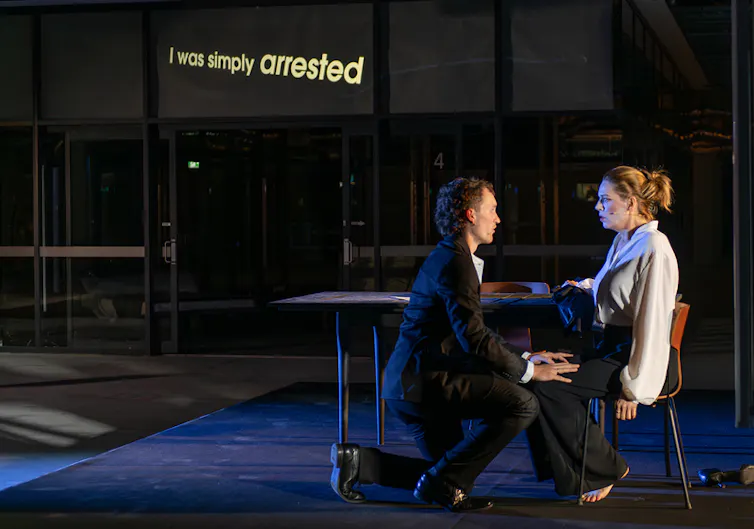 A couple on stage talk.