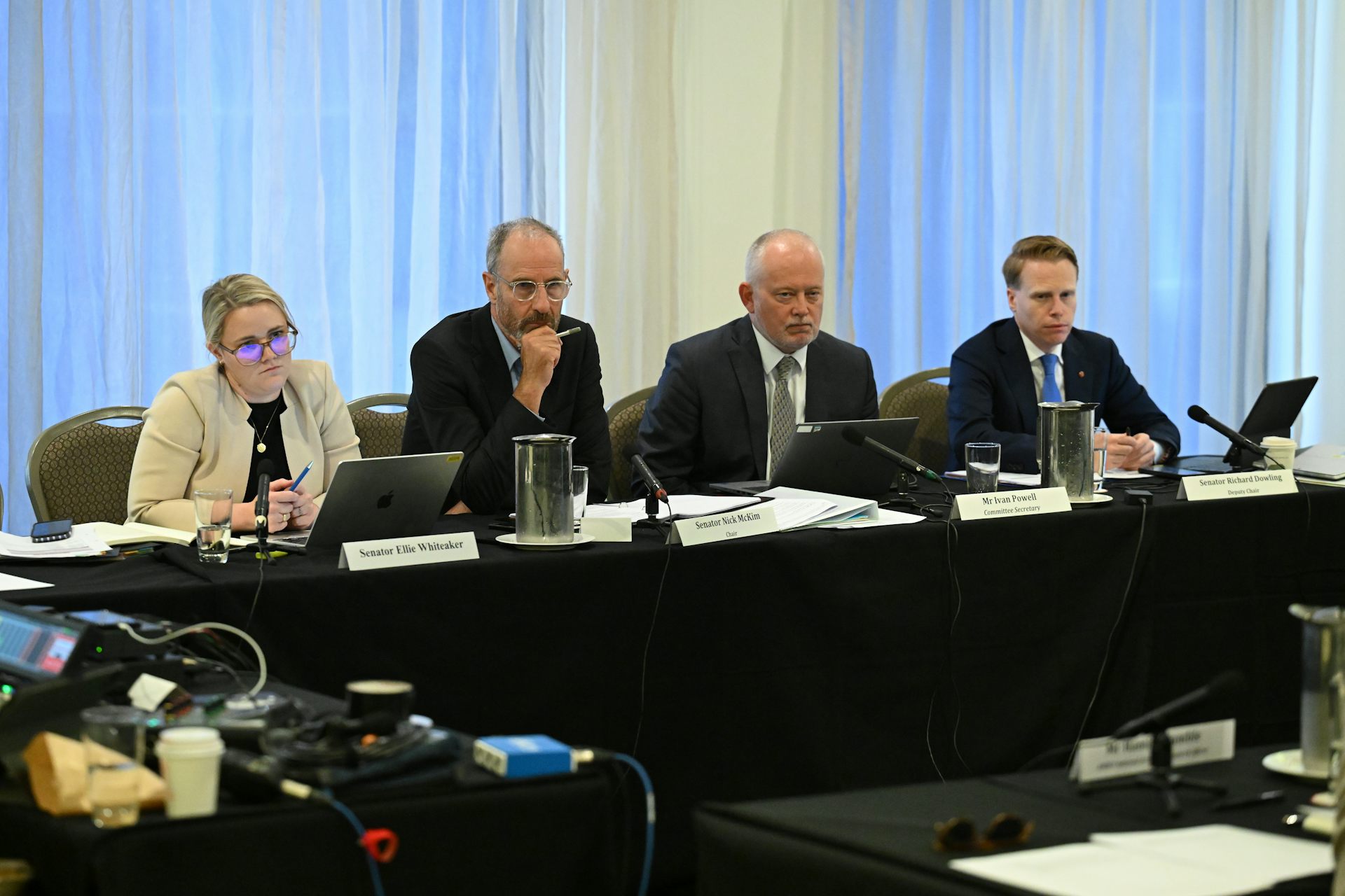 A table of people listening to someone talk