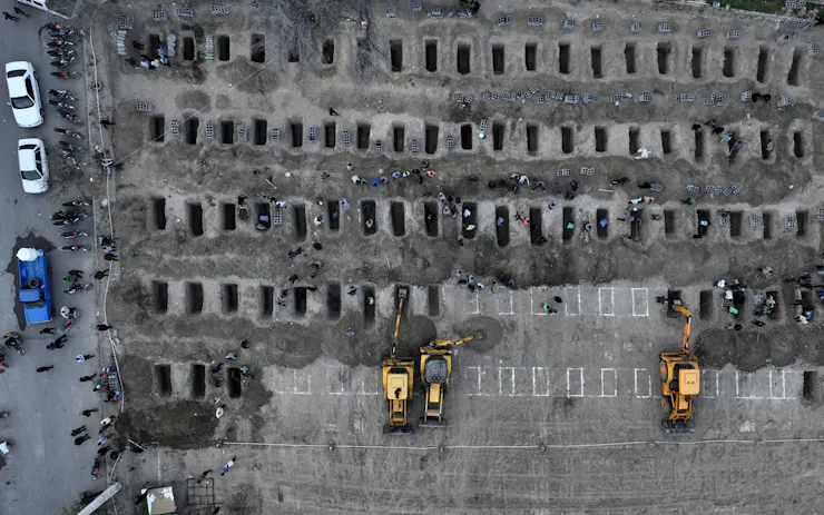 An aerial view of dozens of graves.