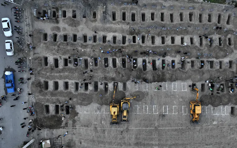 An aerial view of dozens of graves.