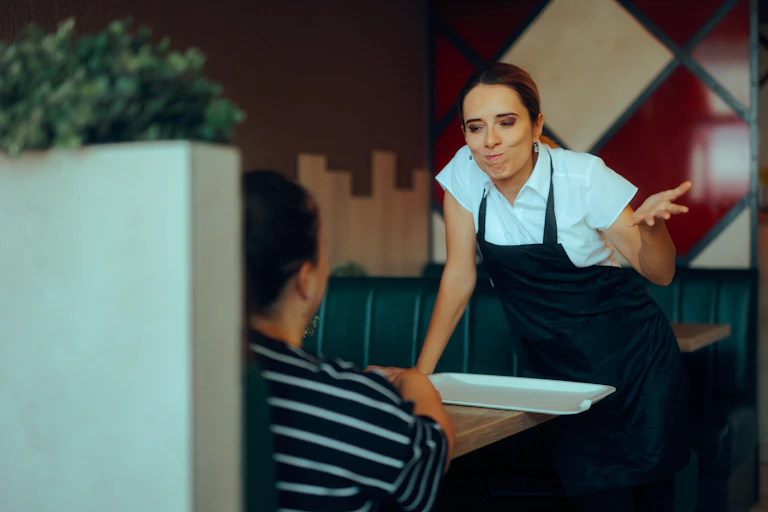 A waitress arguing with a customer in a restaurant
