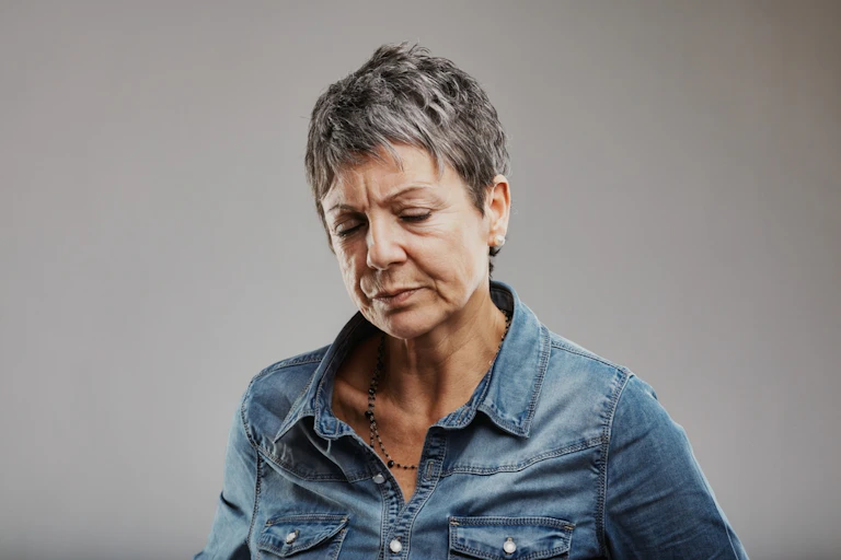 A middle-aged woman looking tired.
