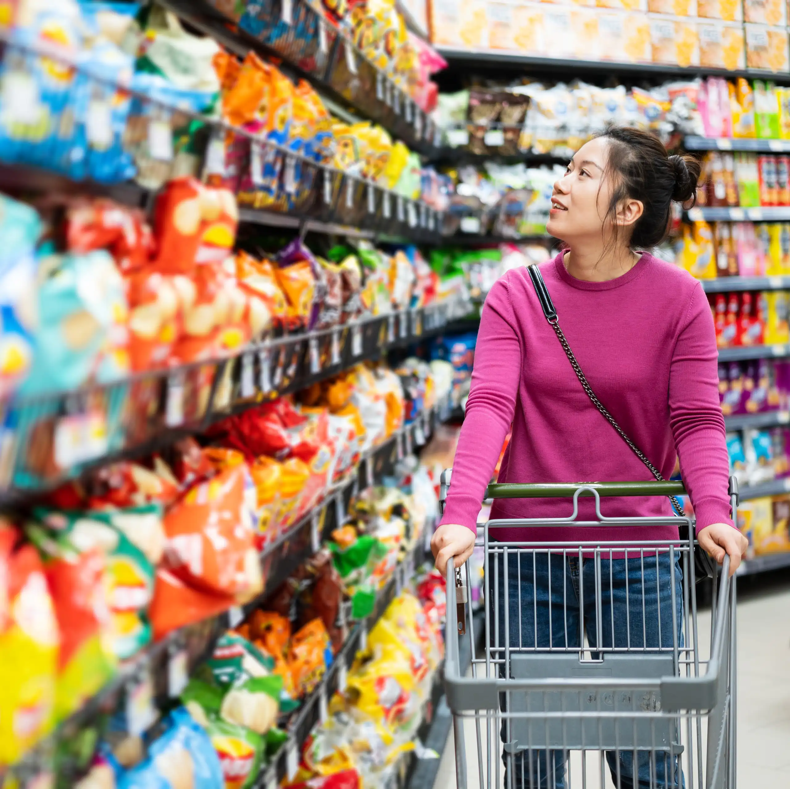 A person walking along a supermarket aisle