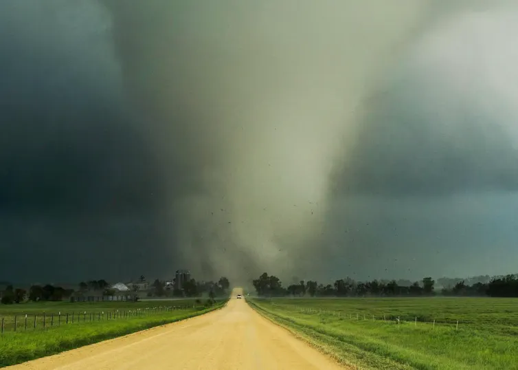Are you able to continue to exist within a twister? This scientist did unintentionally – he’s fortunate to be alive 1 A vehicle drives down a rural road, away from a large tornado.