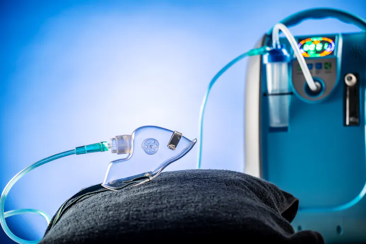 A backpack-size machine with a tube to a breathing mask.