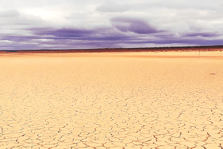 Parched and cracked brown landscape with not a single plant, stretching for miles