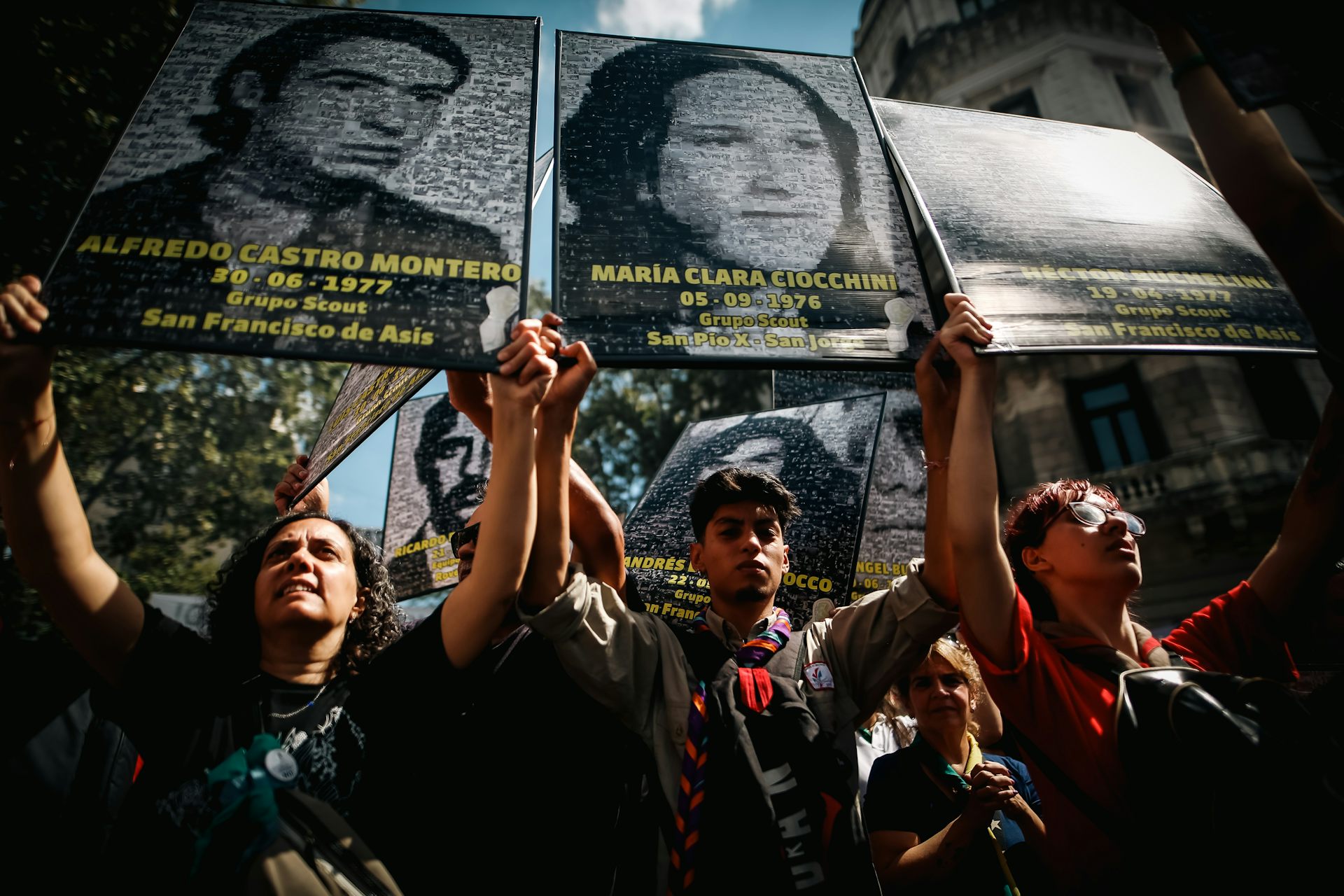 Demonstrators carry pictures of missing people in Argentina.