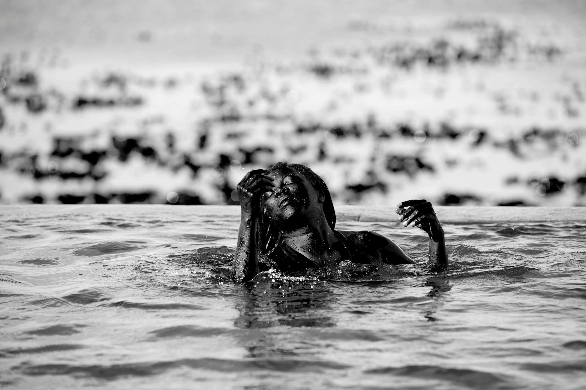 An African woman basks in the ocean.