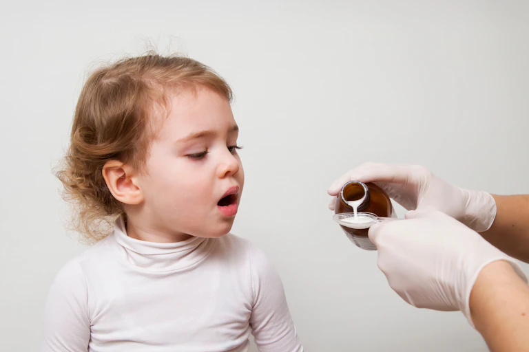 A child being given medicine.