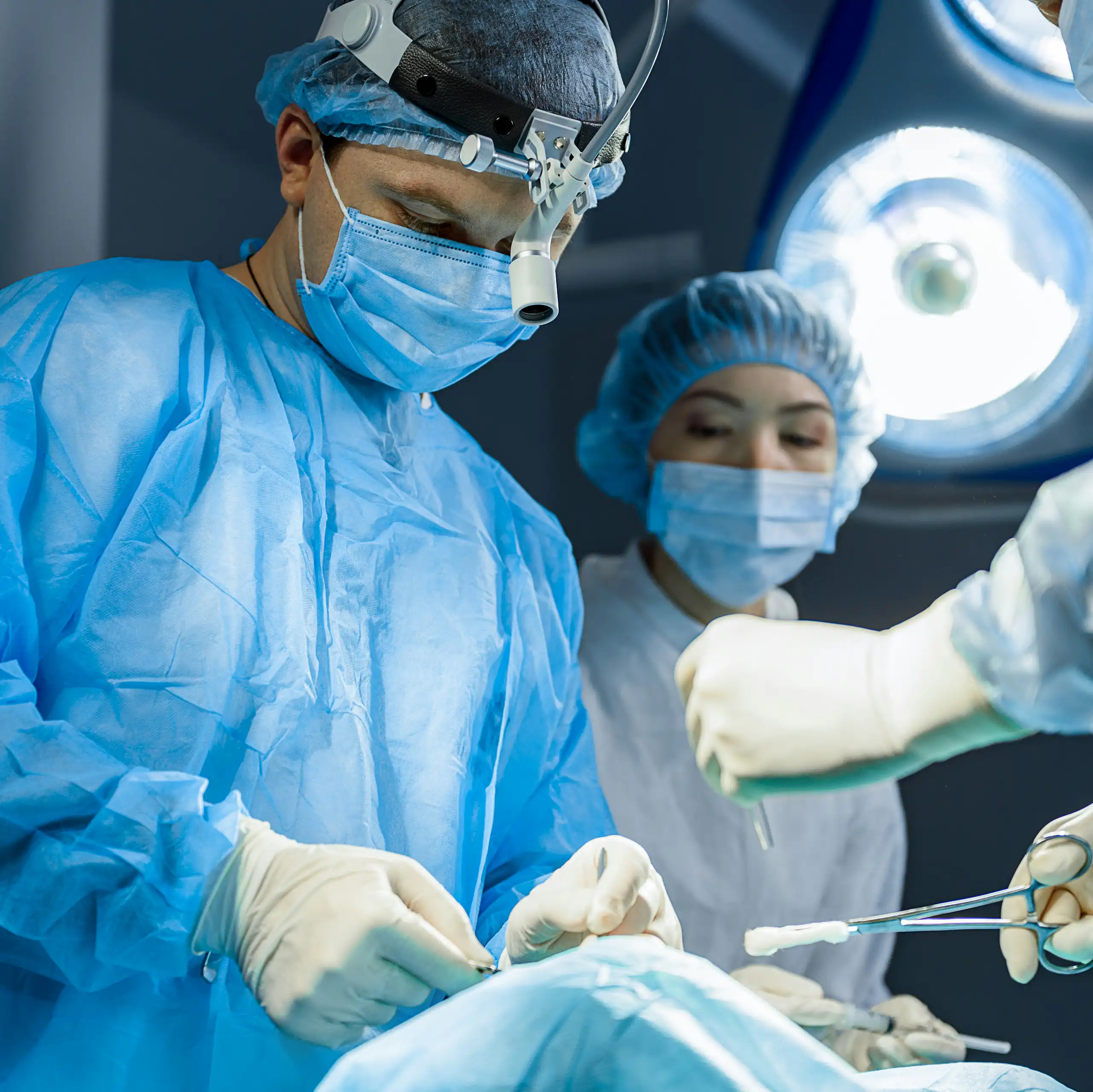 A surgeon operates on a patient in an operating room