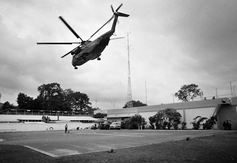 A helicopter taking off from the roof of a building.