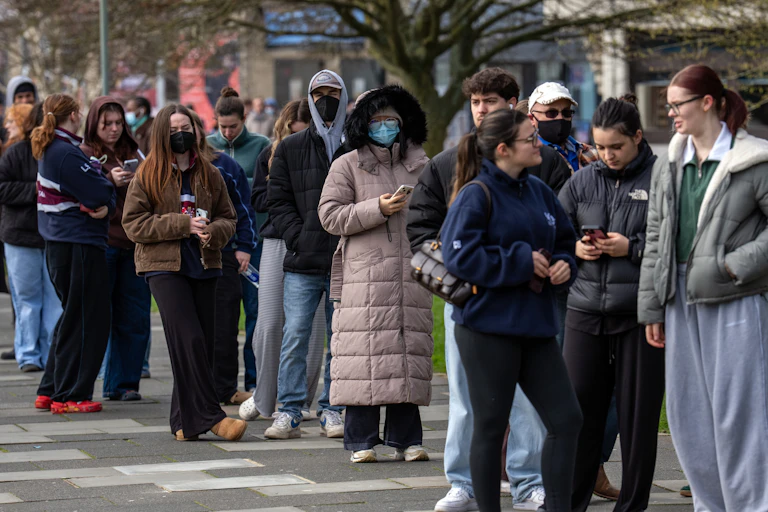 Staff and students queue to receive antibiotics at the University of Kent, UK, after two people died in an outbreak of bacterial meningitis