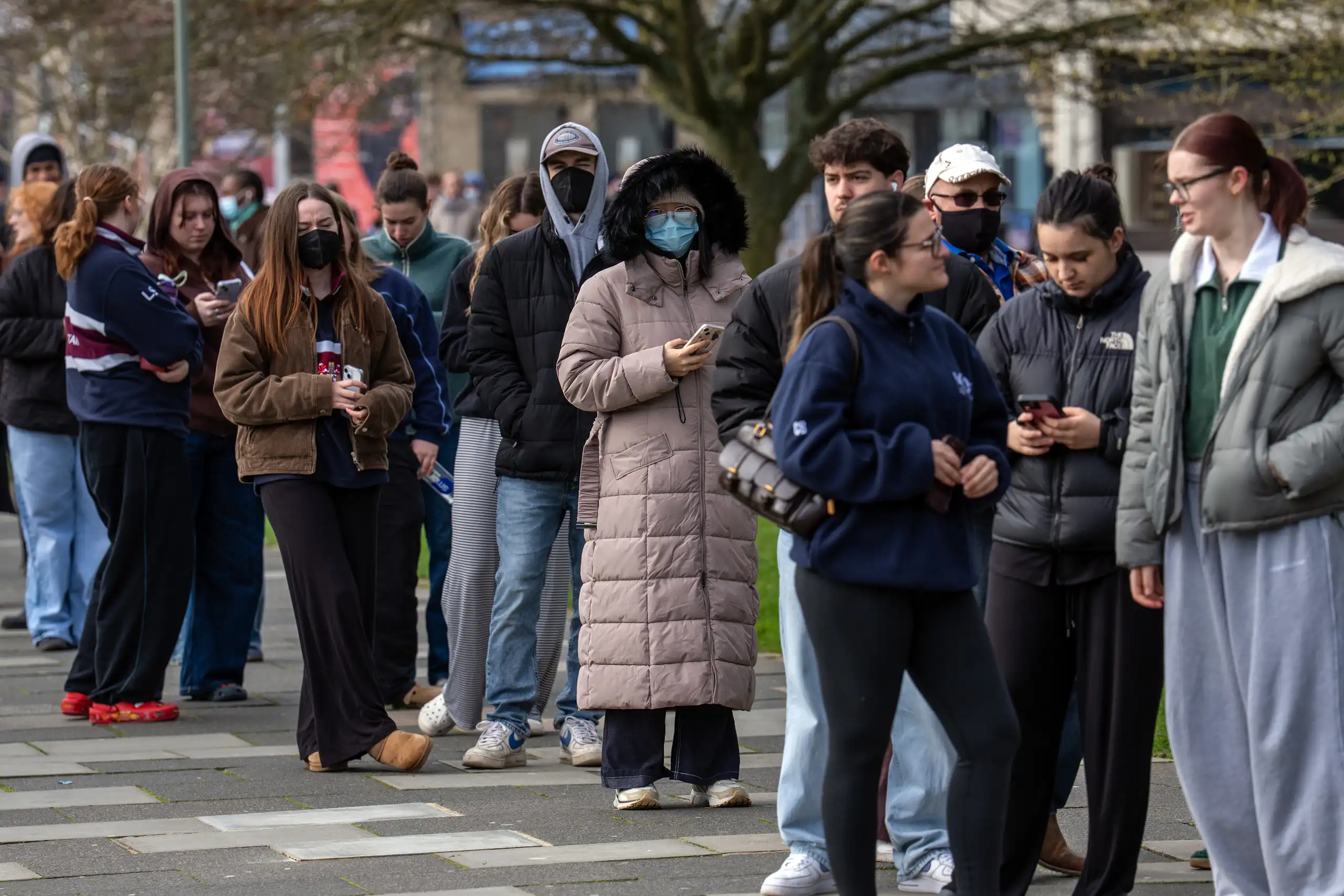 Staff and students queue to receive antibiotics at the University of Kent, UK, after two people died in an outbreak of bacterial meningitis