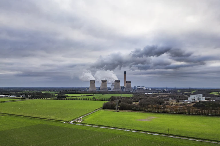 open landscape, green fields with big towers of power station