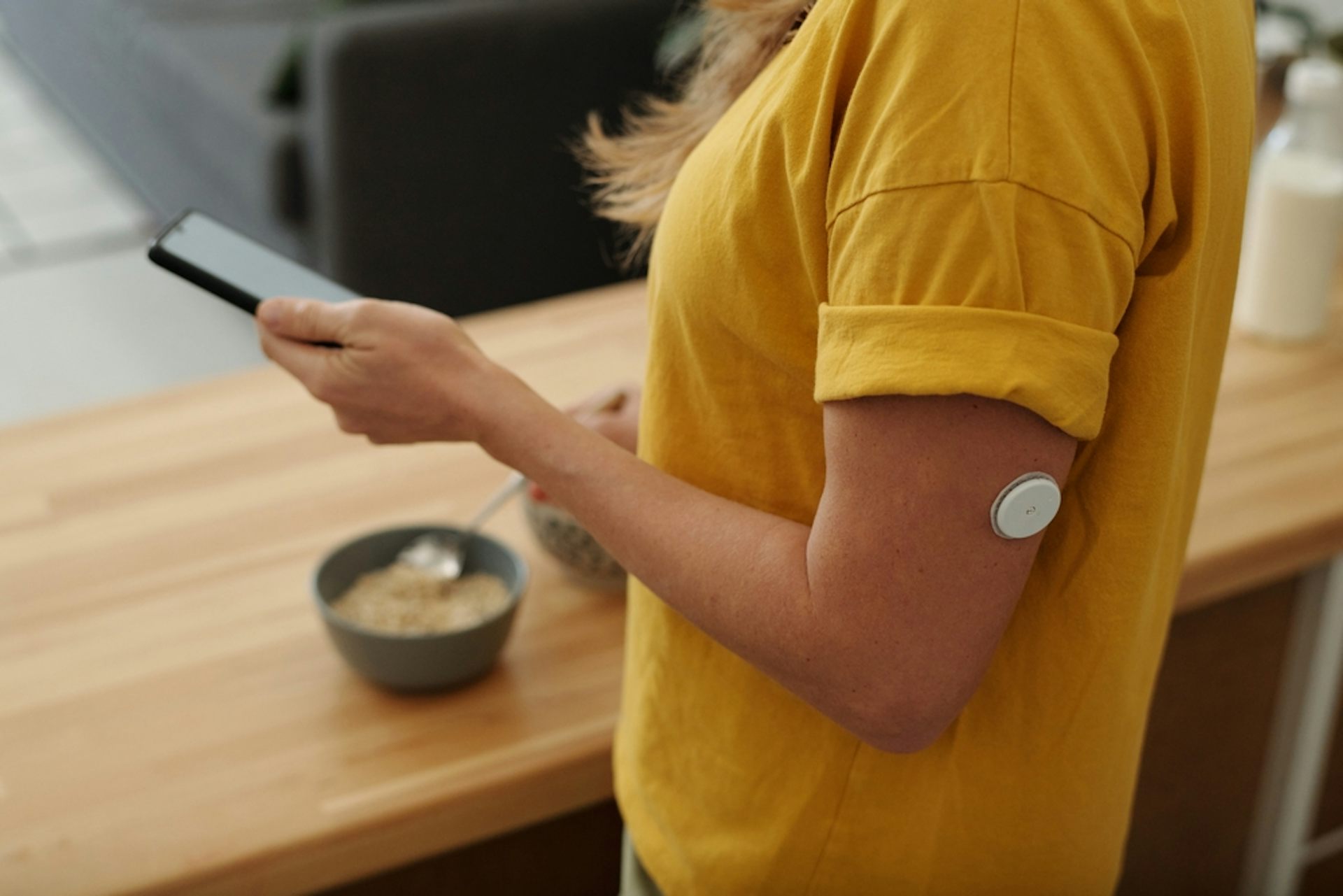 Woman with a patch that monitors glucose levels.