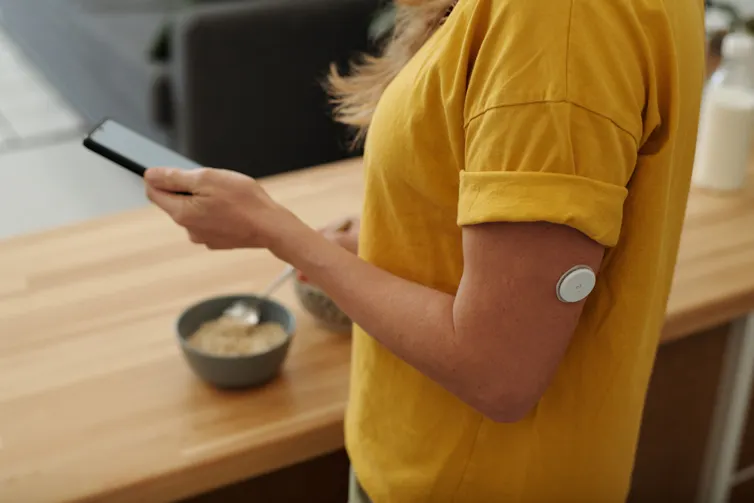 Woman with a patch that monitors glucose levels.