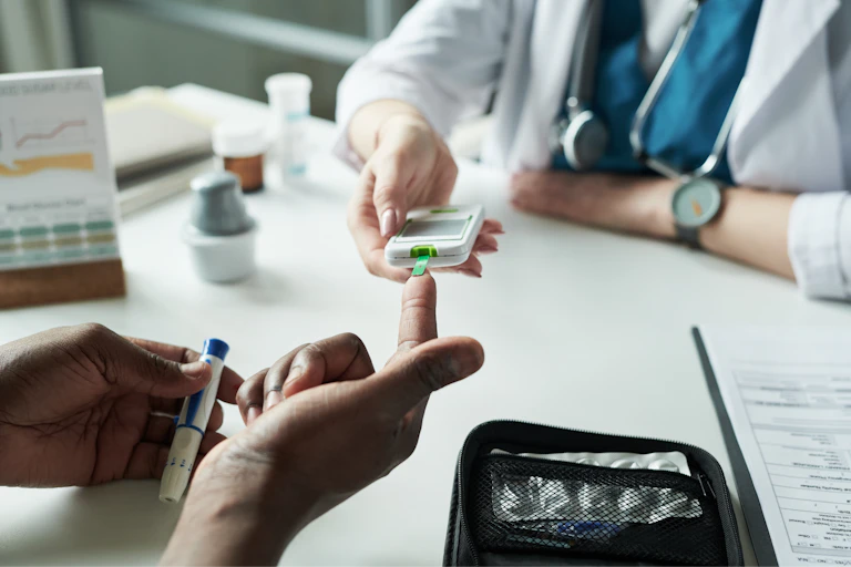 A doctor checking a patient's blood glucose levels.