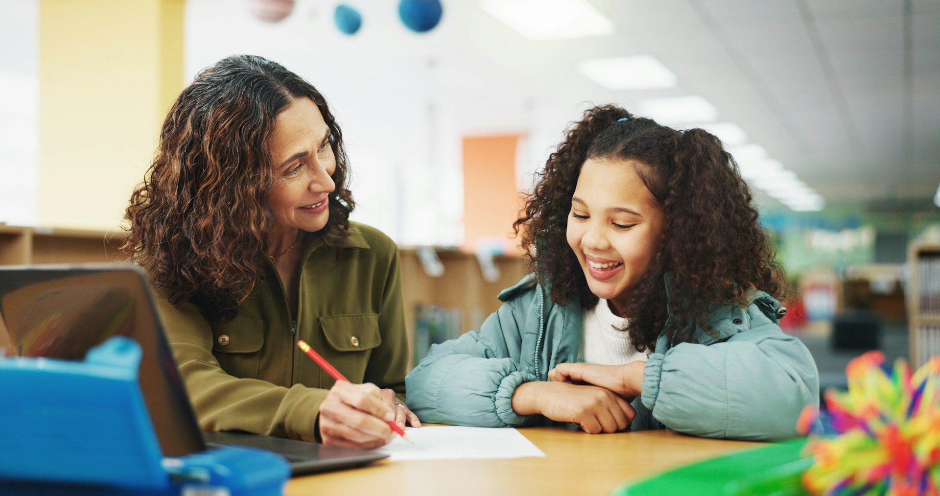 Girl working with teacher