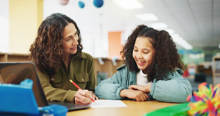Girl working with teacher