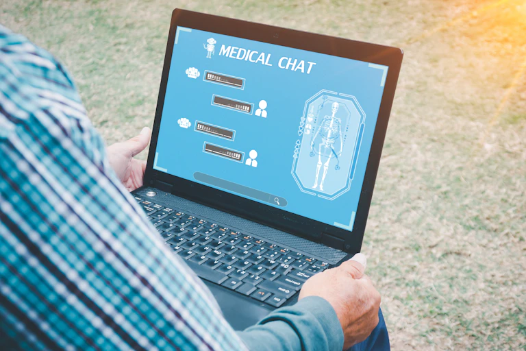 Patient using a laptop to chat with a AI medical chatbot.
