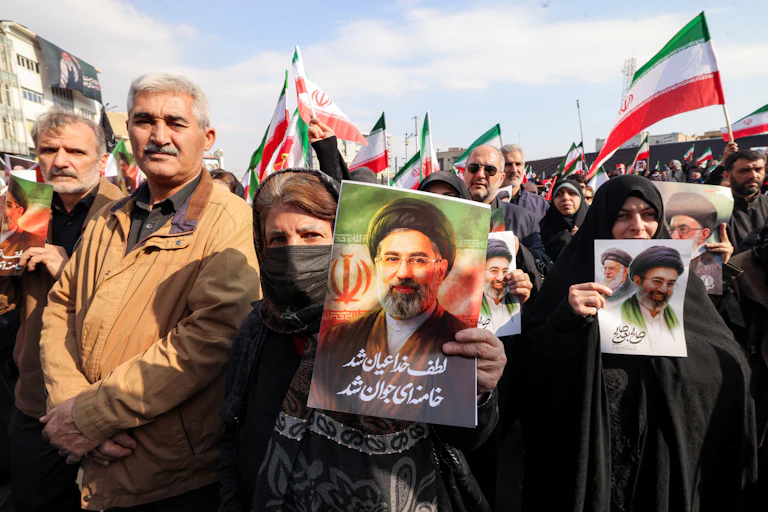A woman holds a picture of a man.