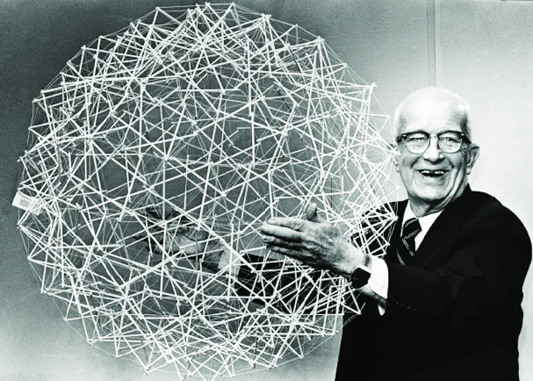 Buckminster Fuller holding a geodesic sphere